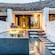 A seated area next to a pool near a cabana in Mykonos, Greece
